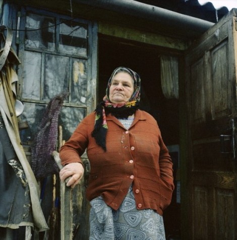 Maria Urupa (77 years) on the porch of her house in Parishev village. When the authorities came to evacuate the village after the accident, Maria decided to hide in the basement with her cows. ‘We didn’t care about radiation, it hunger that scared us the most’ – she said. Chernobyl, Ukraine. December 2010.
