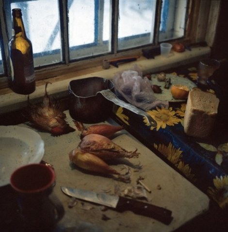 Galina Konyushok butchered a chicken to cook a broth. The food chain has been contaminated with radiation, especially animals that consume local food, such as grain and vegetation from the zone. Zirka village. Chernobyl, Ukraine. December 2010.